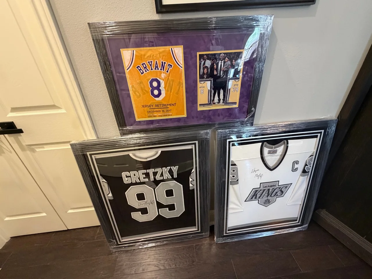 Framed sports jerseys and memorabilia protected with wrapping for handling