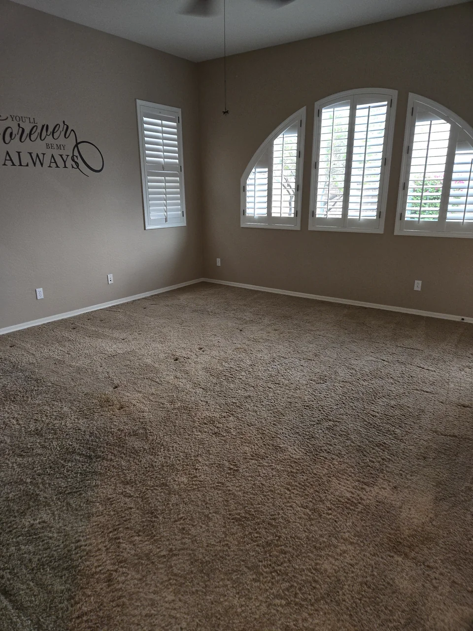 The same estate bedroom with its furniture removed and carpeted floor clear