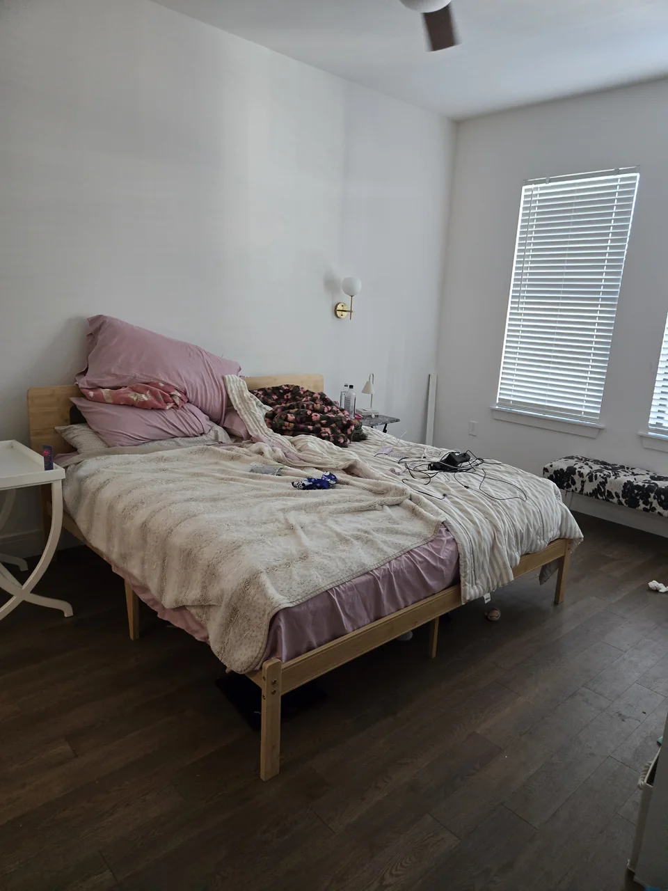 Scottsdale apartment bedroom with a bed, bedding and belongings before the cleanout